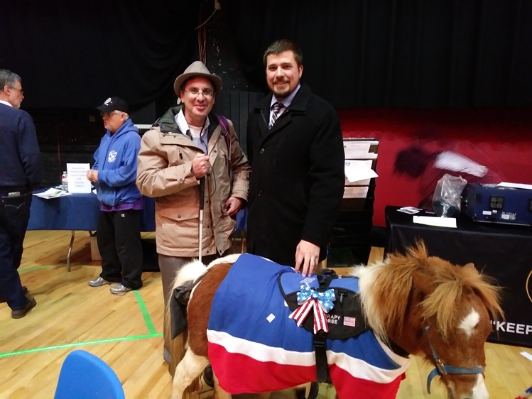 Volunteer Douglas Greenwald and KLS staff attorney Casey Johnson with Henry the therapy horse
